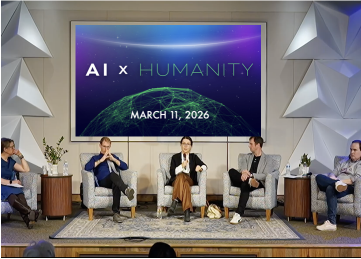 Photo of five people in gray chairs sitting in front of a screen with the words "AI X Humanity" and a globe. 