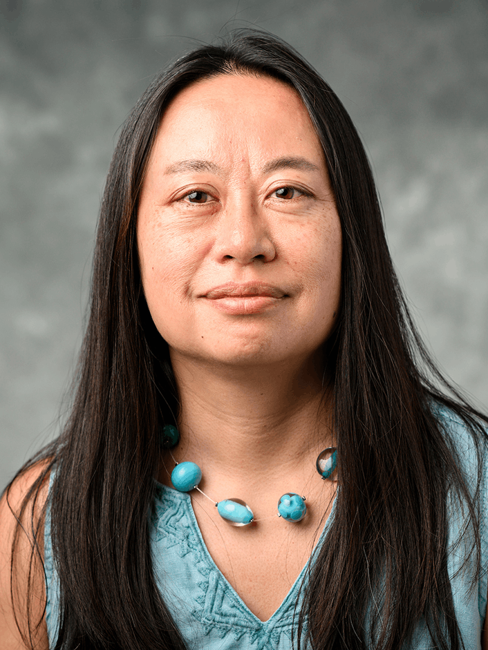 Headshot of Florence Hsia. She has long, straight, black hair, and is wearing a blue beaded necklace and a blue sleeveless shirt.