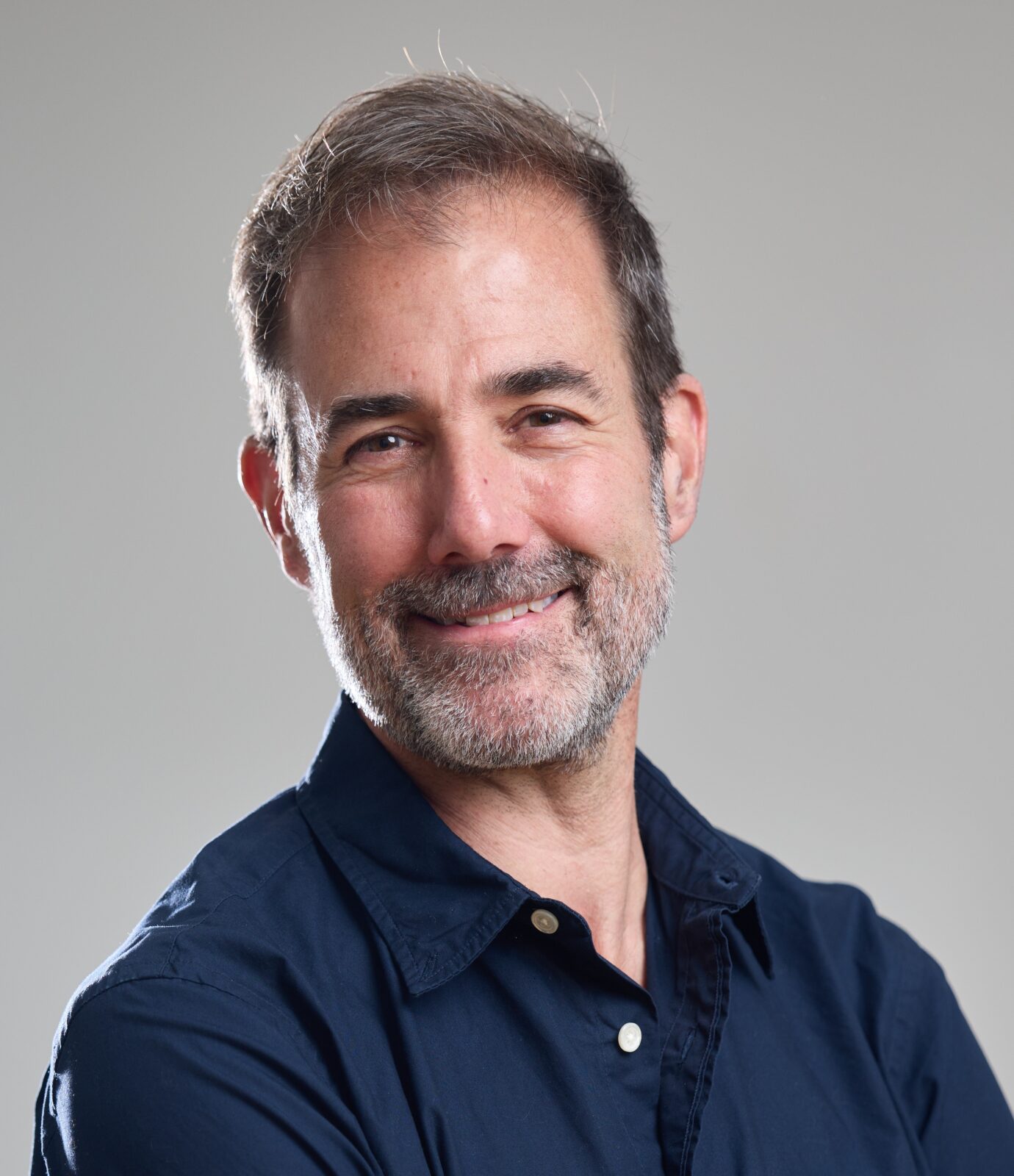 Headshot of Tarleton Gillespie in a navy blue button down shirt.