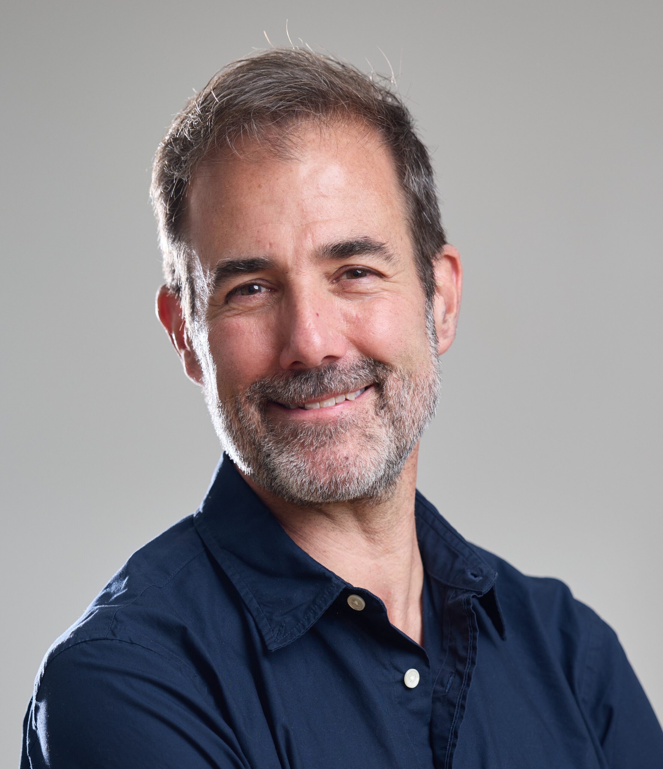 Headshot of Tarleton Gillespie in a navy blue button down shirt.